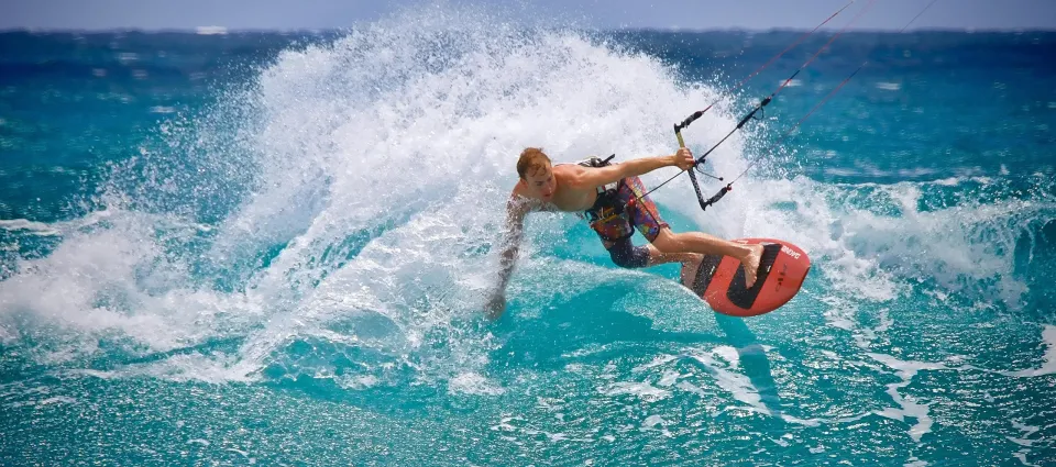 A rider carving through turquoise water in a burst of spray