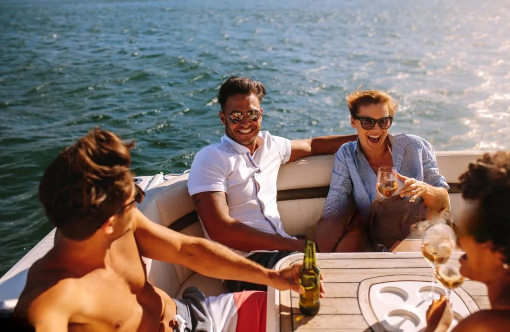 Young people partying on a boat Young people partying on a boat. Men and women laughing and enjoying at yacht party. elite pearl charter