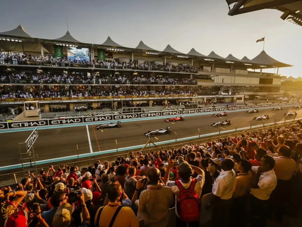 elite pearl charter - f1 drivers ready to start the race while people watching.